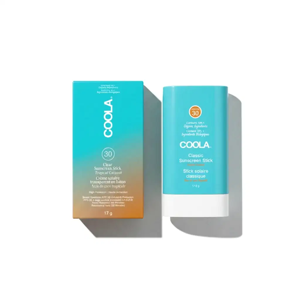 Two Coola sunscreen sticks on a white background